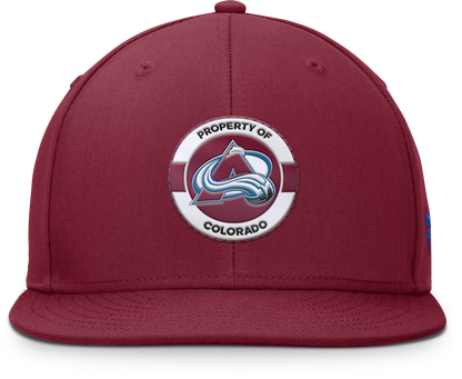 Front of Property of Colorado hat, burgundy background,  Property of Colorado in black lettering. Avalanche logo in the center of lettering