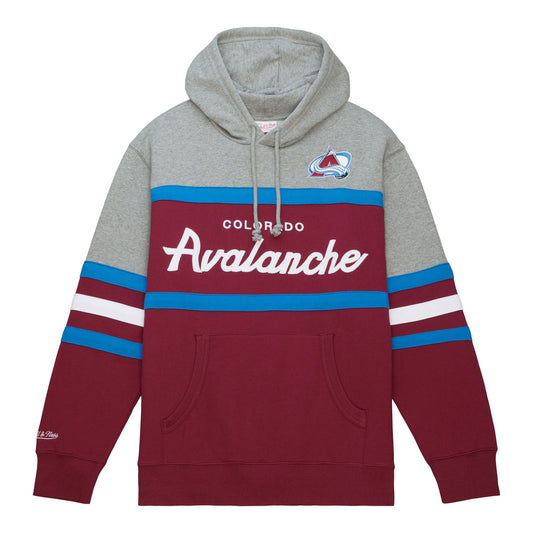 Hoodie sweatshirt with grey hood and shoulders to just  above the elbows. Lower 2/3rds is burgundy with kangaroo pocket, white "Colorado Avalanche" in white font  across the front,  and blue 1 inch bands around chest and waist. Lower sleeves are burgundy with 2 blue bands and 1 white ban at elbows. Small "Mitchell & Ness" logo embroidered at right wrist. Full color Avalanche logo on front of left shoulder. 