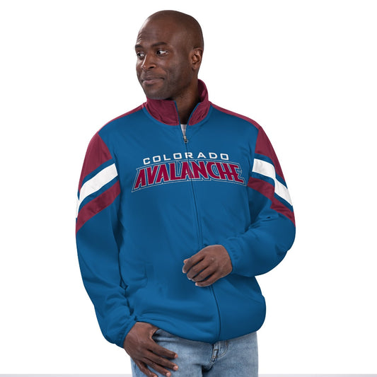 Front of blue full zip jacket.  Slash pockets on sides and burgundy mock collar. Shoulders are burgundy with a white then burgundy stripe angled from the front of shoulder back around the arm. "Colorado" in capital letter white font and "Avalanche" in burgundy with white outline across the chest. 